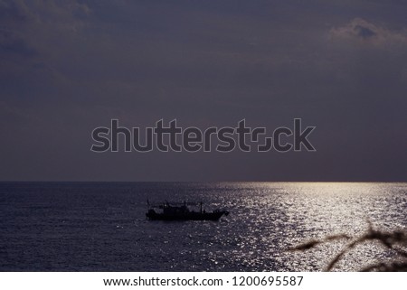 a fishing boat off the coast of Jeju island under sunny cloud