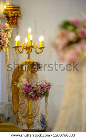 Angel statue holding lamp 