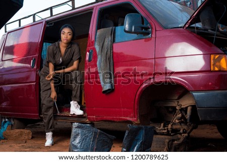 a female mechanic working on a vehicle