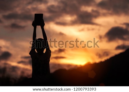Children holding christian Bible with light sunset background,christian concept.