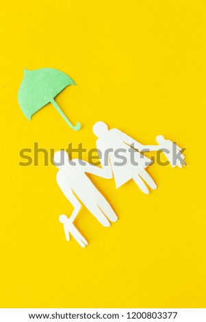 Illustration of social security concept. Financial protection. Family silhouette, cutout under umbrella on yellow background top view copy space