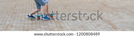 legs on blue skateboard close up, long photo