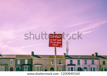 "Danger" sign with purplish and pinkish sky