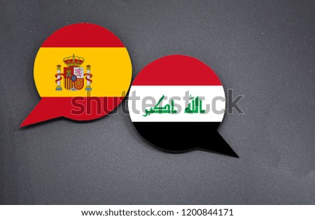 Spain and Iraq flags with two speech bubbles on dark gray background