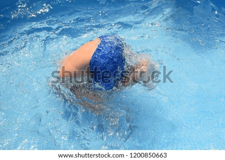 Teenager having fun jumping in swimming pool