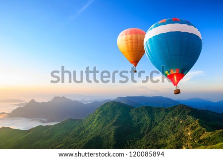 Colorful hot-air balloons flying over the mountain Royalty-Free Stock Photo #120085894