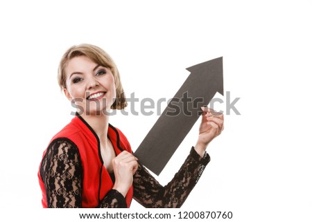 Make choice concept. Elegant woman in red with big black arrow sin symbol pointing. Young girl present show right direction to decide and solve problems.
