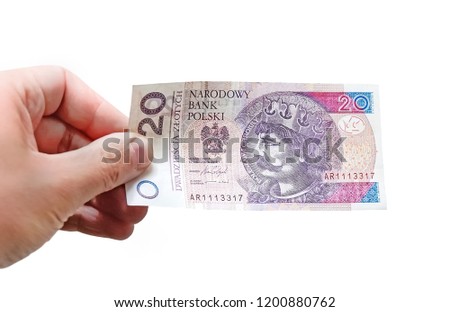 Close up on a 20 zloty banknote in a man's hand. Isolated object on white background.