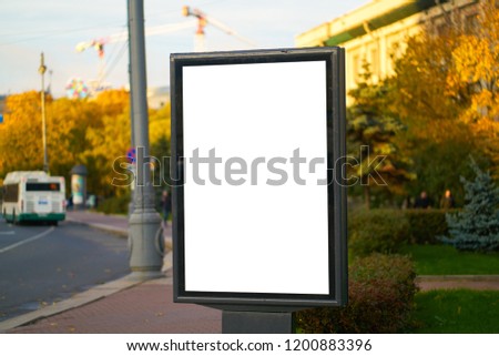advertising space under the poster. Lightposter citylight mockup small billboard in the city near the roadway white space for advertising.