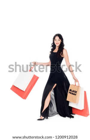 beautiful elegant woman in black dress with shopping bags isolated on white