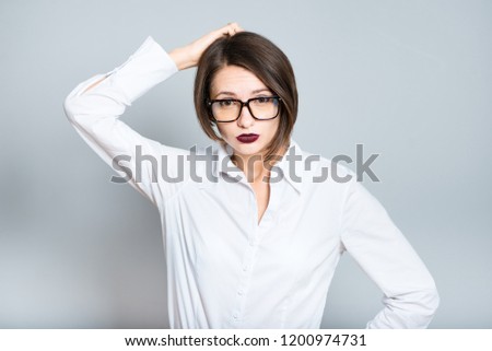 portrait of a business woman scratches her head in confusion, short hair, isolated on background