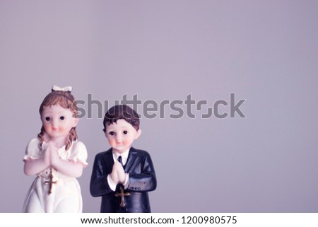 Cake topper Catholic holy communion ceremony religious boy and girl praying to Christian God in church.