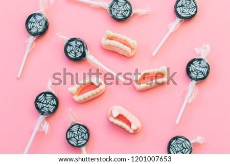 Vampire fangs candys and lollipops with cobwebs. Halloween holiday concept.  