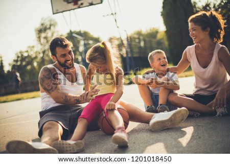 Time for family. Family on basketball playground. 