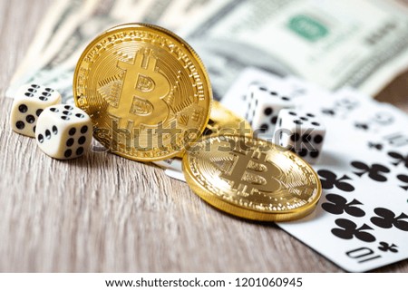 Bitcoins, cards, dices on wooden background. Cryptocurrencie gambling concept