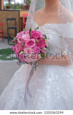 Bride with a bouquet of pink roses
