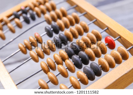 Vintage wooden abacus on old board surface.