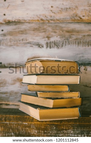 time to read books. books on the table. wooden background. vintage.