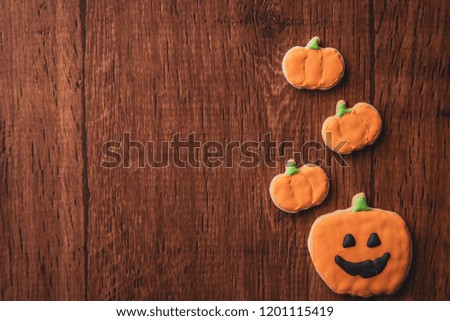 Fresh delicious homemade decorated halloween cookies sweets on dark wooden background, concept of halloween party, copy space(text space), top view, blank for text.