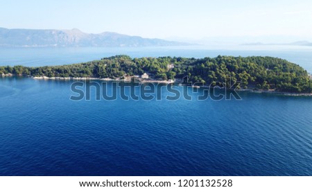 Aerial drone bird's eye view photo of iconic historical small island of Vidos a few nautical miles away from Corfu old town, Corfu island, Ionian, Greece