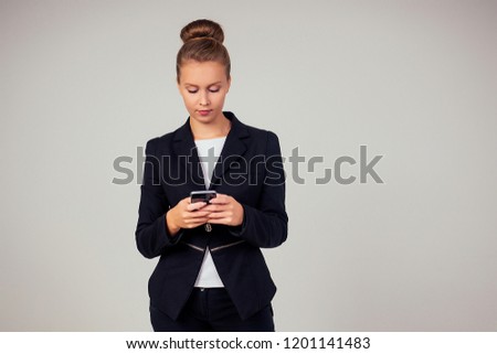beautiful woman in a business black suit in the studio on a white background