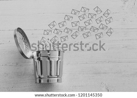 group of emails going into the bin, metaphor of spam or clearin up your inbox Royalty-Free Stock Photo #1201145350