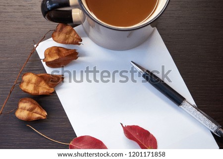 Autumn  leaves, pen and paper on the table. Autumn composition 