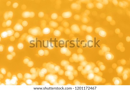 Yellow bokeh background texture. Golden blurred bright glare of light texture