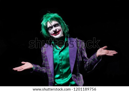 Halloween costume clown.Holiday photo of scary man. Man with green hair and white face. Spooky Character Halloween.