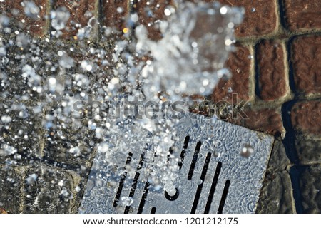 Fountain closeup on brick background