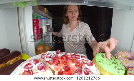Woman opens the refrigerator at night. night hunger. diet gluttony Royalty-Free Stock Photo #1201212766