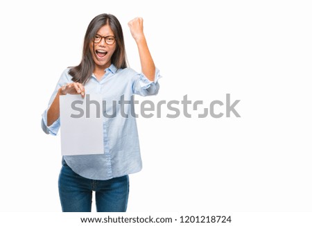 Young asian woman over isolated background holding blank paper annoyed and frustrated shouting with anger, crazy and yelling with raised hand, anger concept