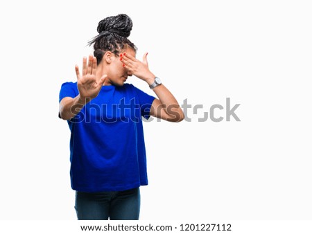 Young braided hair african american girl wearing glasses over isolated background covering eyes with hands and doing stop gesture with sad and fear expression. Embarrassed and negative concept.