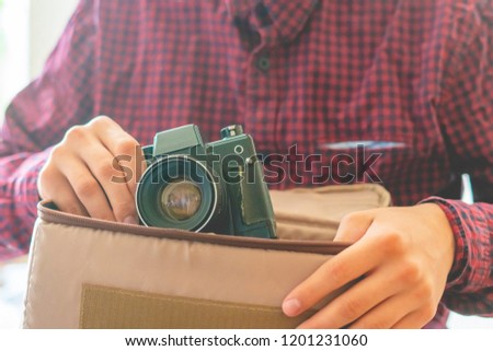 close up young person hands holding a vintage camera 