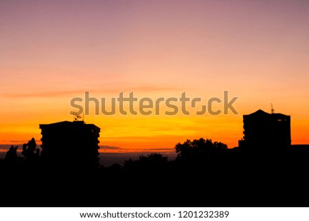 Silhouette image morning sunrise. Beautiful golden sky. Black shadow building.
