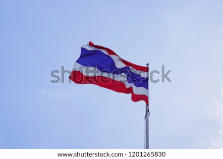 Thailand flag blowing by the wind with blue sky 