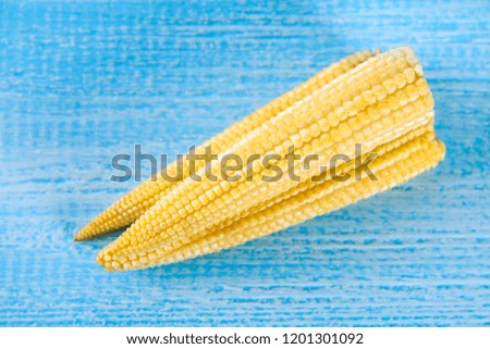 Baby sweetcorn or mini corn. It is typically the eaten whole cob included for the human consumption. It is eaten both raw and cooked. Baby corn is common in stir fry dishes.
