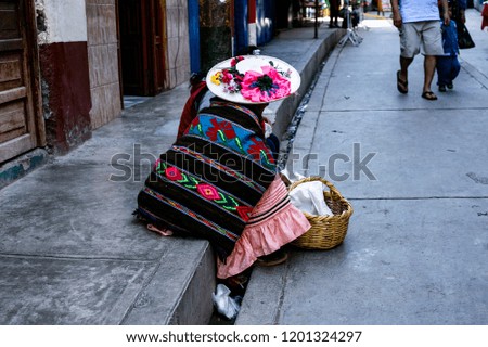 Peruvian woman with her typical clothes sells in the streets