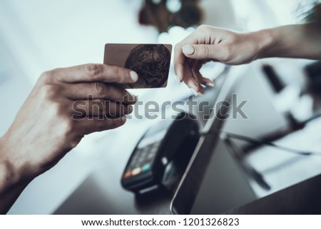 Close up. Man Giving Woman Bank Card for Payment. Banking and Economy Concepts. Man's Hand with Card. Woman's Hand. Business Concept. Money on Card. Modern Economy. Worker in Bank.