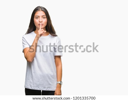 Young beautiful arab woman over isolated background asking to be quiet with finger on lips. Silence and secret concept.