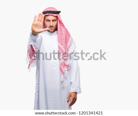 Young handsome man wearing keffiyeh over isolated background doing stop sing with palm of the hand. Warning expression with negative and serious gesture on the face.