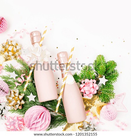 Pastel Pink confetti, champagne bottles and decorations. Flat lay, top view. Holiday composition for  New year or Christmas celebration. Flat lay, top view