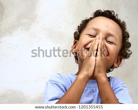 little boy praying to God with hands together and a smile on his face with head held high stock image stock photo  Royalty-Free Stock Photo #1201355455