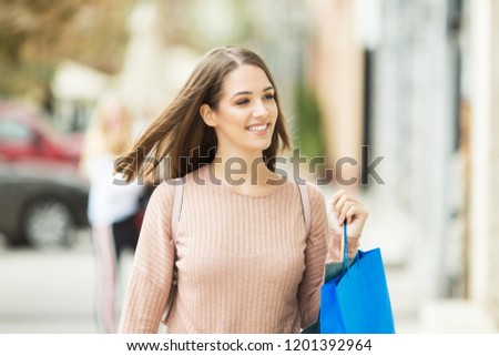 Young beautiful woman with shopping bags outdoors