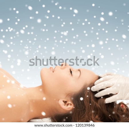 picture of beautiful woman in massage salon with snow
