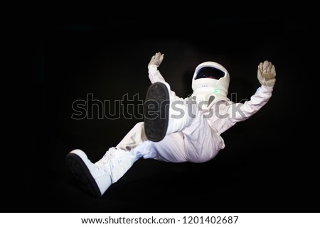 falling Astronaut in space, in zero gravity on black background. Royalty-Free Stock Photo #1201402687