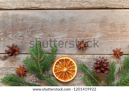 Christmas New Year composition frame with fir branch pine cones orange slices on old shabby rustic wooden background. Xmas holiday december decoration. Flat lay copy space Time for celebration concept