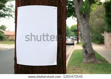 Blank sign stapled to a telephone pole