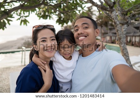 Portrait of happy family selfie side swimming pool at summer