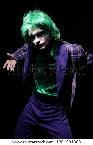 Halloween costume clown.Holiday photo of scary man. Creepy joker with face angry.